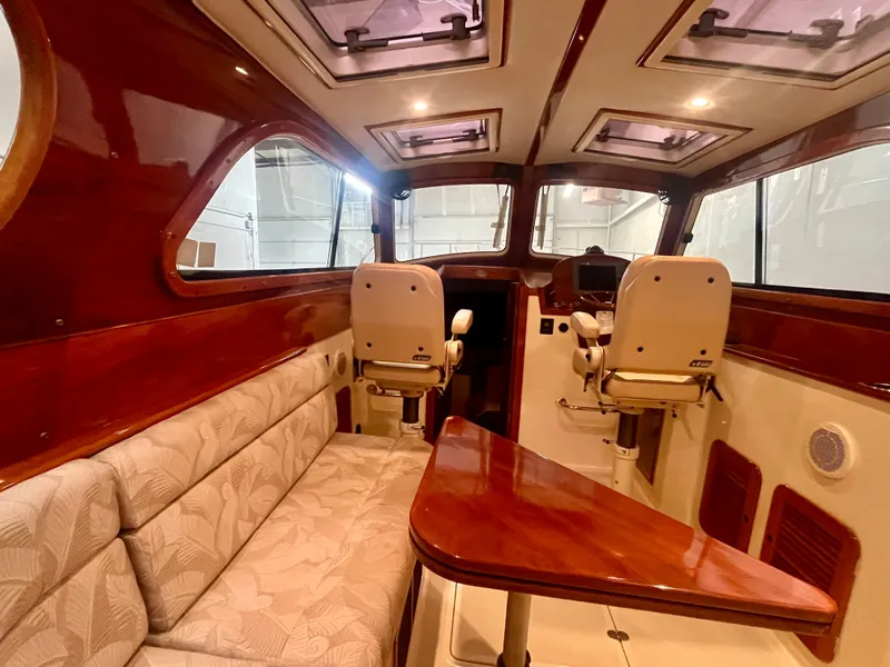 Slide: The Image of Interior of 2005 Hinckley Picnic Boat EP with elegant seating and wooden finishes. - 5