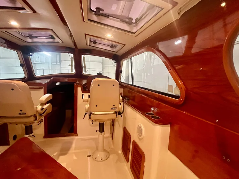 Slide: The Image of Interior of 2005 Hinckley Picnic Boat EP with wooden accents and seating. - 8