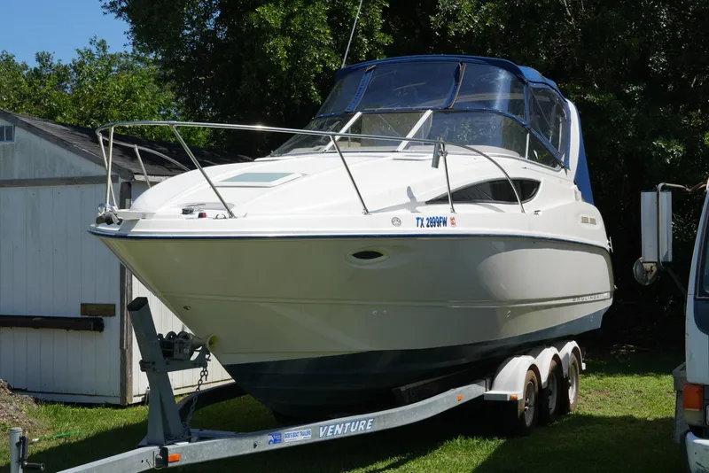 Slide: The Image of 2003 Bayliner Ciera 2855 boat on trailer, parked outdoors. - 1