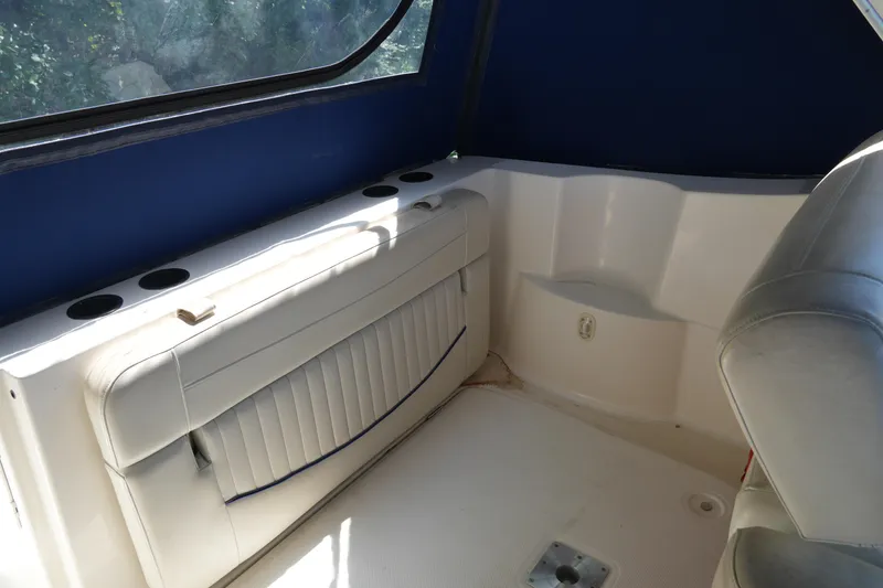 Slide: The Image of 2003 Bayliner Ciera 2855 interior with blue canopy and white seating. - 10