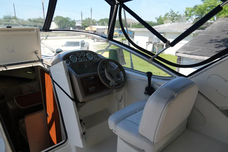 Slide: The Image of 2003 Bayliner Ciera 2855 cockpit with steering wheel and control panel. - 12