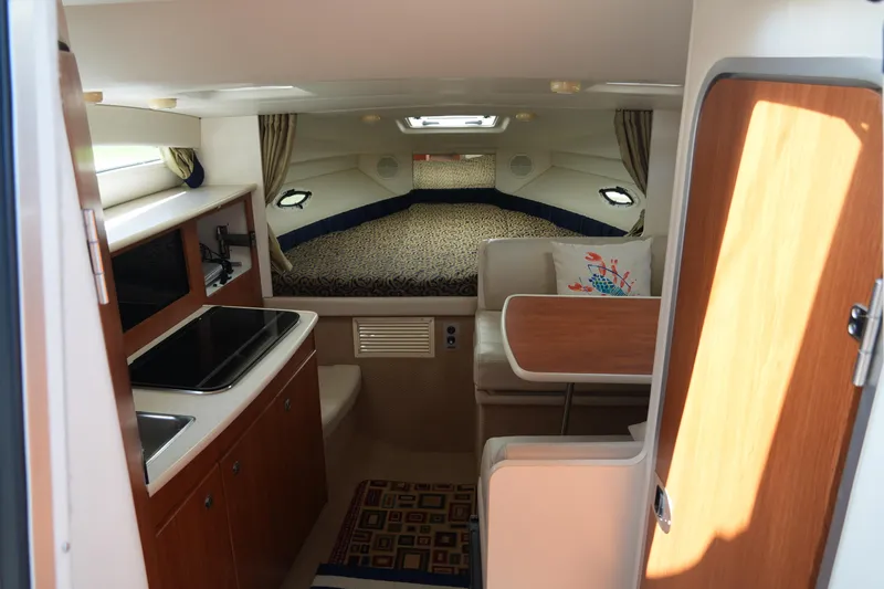 Slide: The Image of Interior of 2003 Bayliner Ciera 2855 boat with kitchenette and cozy sleeping area. - 14