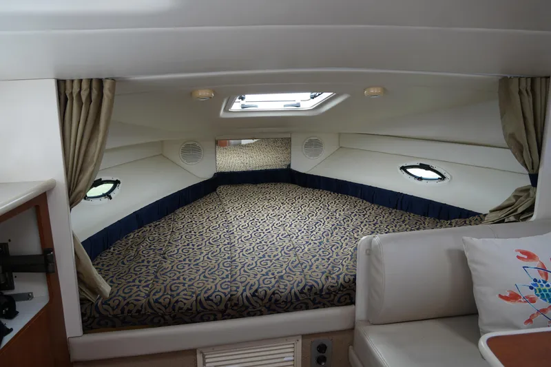Slide: The Image of 2003 Bayliner Ciera 2855 cabin interior with cozy bed and elegant decor. - 15