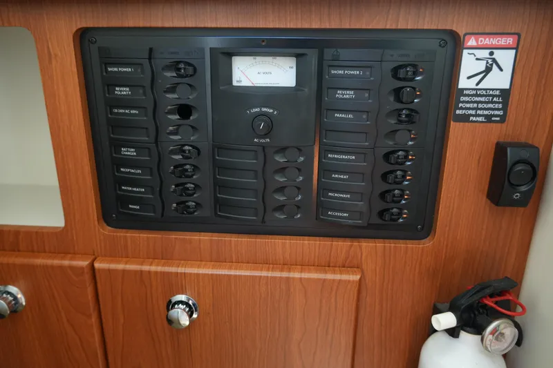 Slide: The Image of Electrical control panel on 2003 Bayliner Ciera 2855 boat, featuring switches and safety warning. - 21