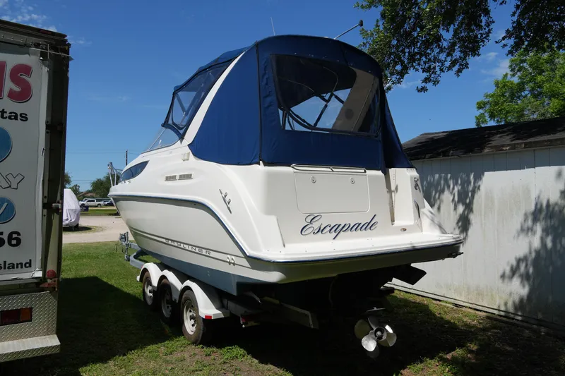 Slide: The Image of 2003 Bayliner Ciera 2855 boat on trailer, blue canopy, parked outdoors. - 3