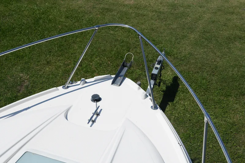 Slide: The Image of Bow of 2003 Bayliner Ciera 2855 boat on grass, featuring railings and anchor. - 4
