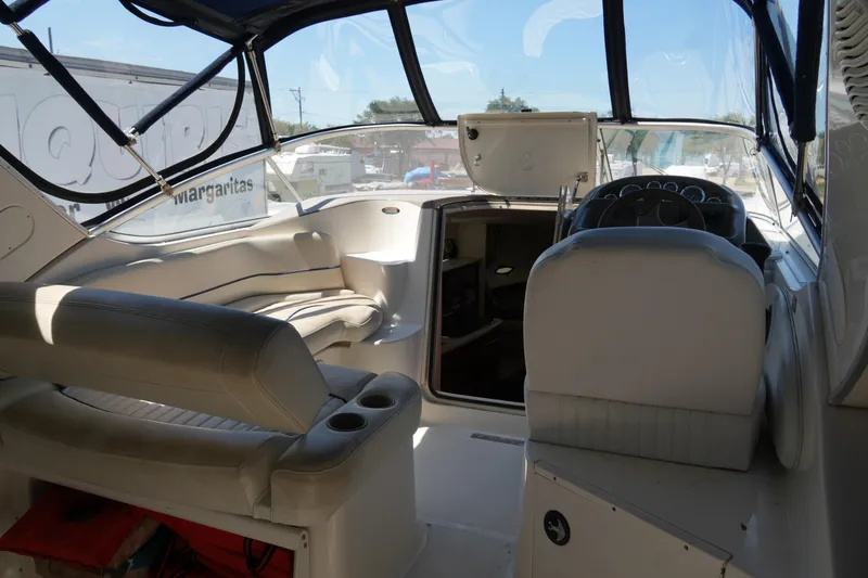 Slide: The Image of 2003 Bayliner Ciera 2855 boat interior with seating and helm, featuring a spacious cockpit area. - 9