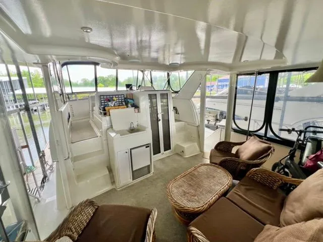 Slide: The Image of 1998 Carver 405 Motor Yacht interior with seating, kitchenette, and helm station. - 10