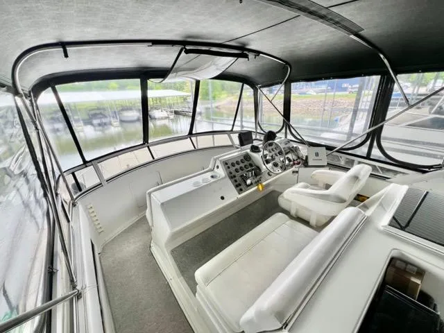 Slide: The Image of 1998 Carver 405 Motor Yacht helm with panoramic windows and modern controls. - 11