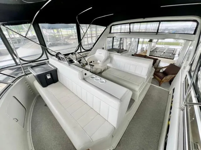 Slide: The Image of 1998 Carver 405 Motor Yacht interior with spacious seating and helm station. - 12