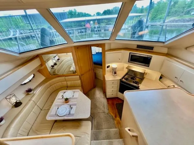 Slide: The Image of Interior of 1998 Carver 405 Motor Yacht with dining area and kitchen. - 17