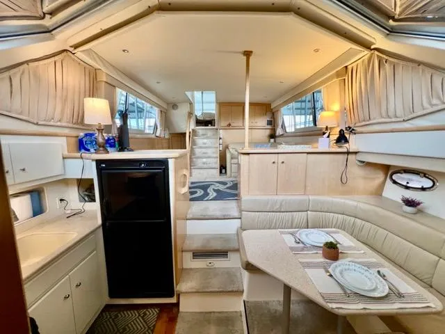 Slide: The Image of Interior of a 1998 Carver 405 Motor Yacht with dining area and kitchen. - 23