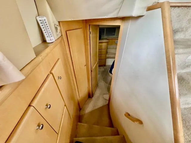 Slide: The Image of 1998 Carver 405 Motor Yacht interior with wooden cabinetry and narrow staircase. - 24