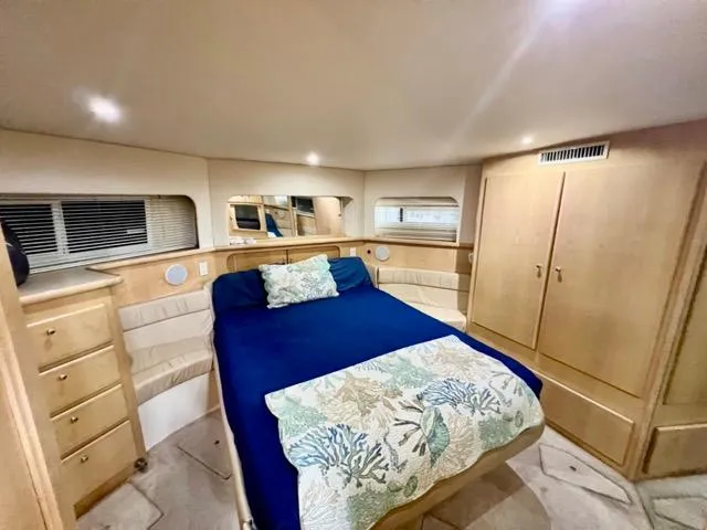 Slide: The Image of Luxurious bedroom interior of 1998 Carver 405 Motor Yacht with cozy bed and elegant decor. - 25