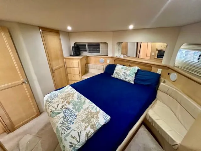 Slide: The Image of Luxurious bedroom interior of 1998 Carver 405 Motor Yacht with cozy bedding and wood accents. - 26