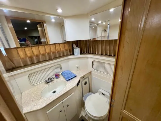 Slide: The Image of Bathroom interior of 1998 Carver 405 Motor Yacht with sink and toilet. - 28