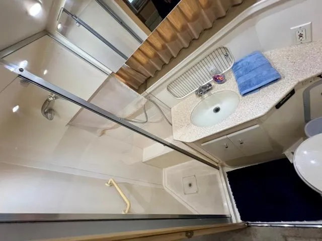 Slide: The Image of Bathroom interior of 1998 Carver 405 Motor Yacht with shower, sink, and countertop. - 29