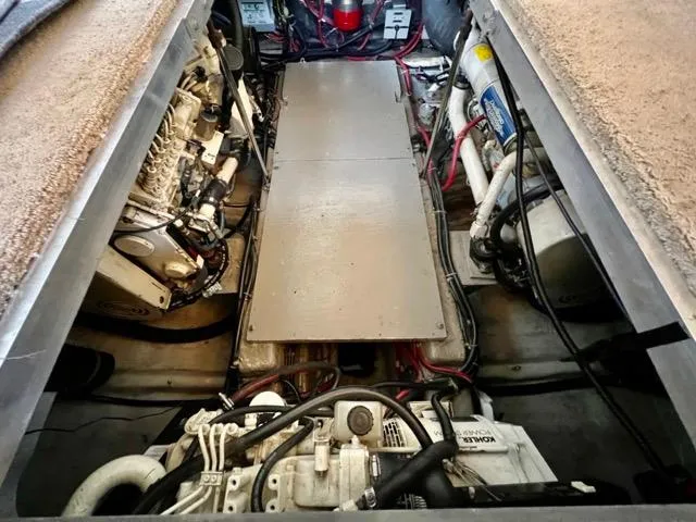Slide: The Image of Engine room of a 1998 Carver 405 Motor Yacht, showcasing mechanical components and wiring. - 31