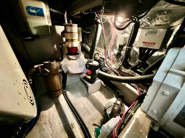 Slide: The Image of Engine room of 1998 Carver 405 Motor Yacht with visible mechanical components and wiring. - 33