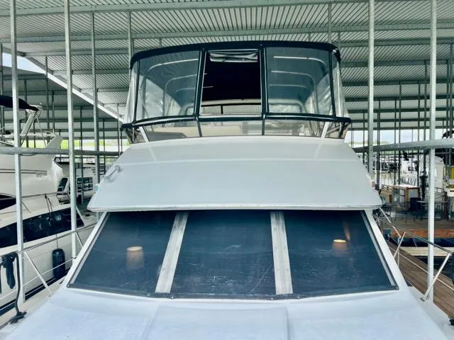Slide: The Image of 1998 Carver 405 Motor Yacht docked in a covered marina. - 38