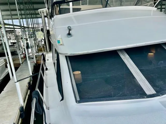 Slide: The Image of 1998 Carver 405 Motor Yacht docked in a covered marina. - 39