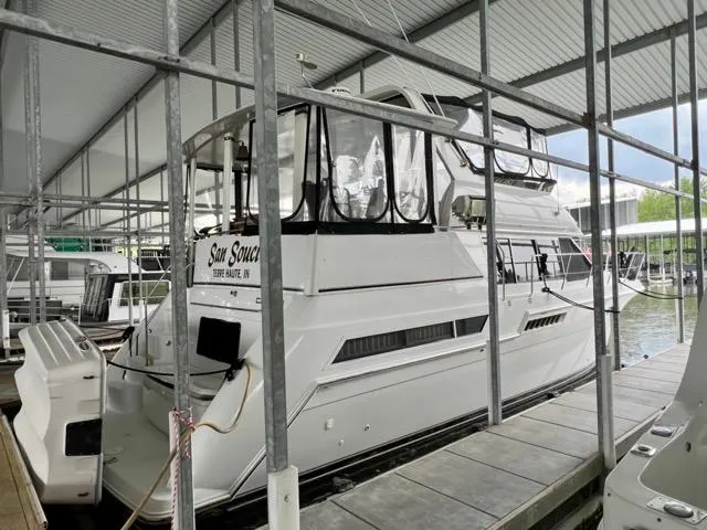 Slide: The Image of 1998 Carver 405 Motor Yacht docked in a covered marina. - 4