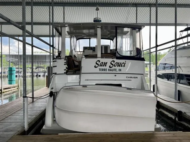 Slide: The Image of 1998 Carver 405 Motor Yacht docked, rear view, with "San Souci" name visible. - 5