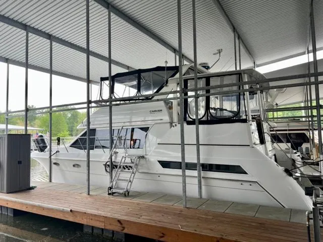 Slide: The Image of 1998 Carver 405 Motor Yacht docked under covered marina. - 6