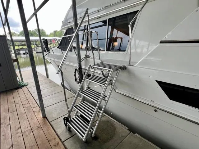 Slide: The Image of 1998 Carver 405 Motor Yacht docked with metal boarding ladder. - 9