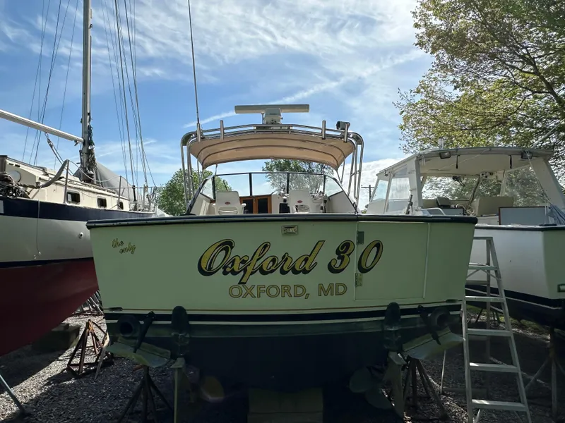 Slide: The Image of 1988 Black Watch 30 EXPRESS boat named "Oxford 30" in a marina setting. - 2