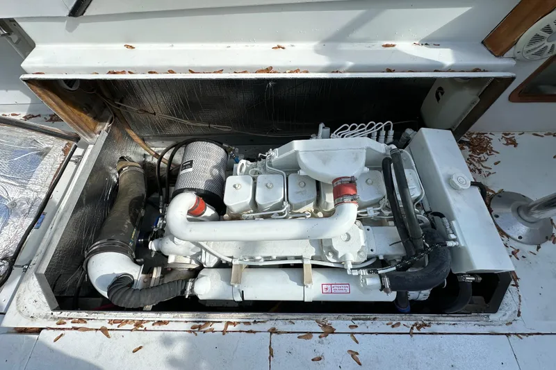 Slide: The Image of Engine compartment of a 1988 Black Watch 30 EXPRESS boat, showcasing the engine and components. - 3