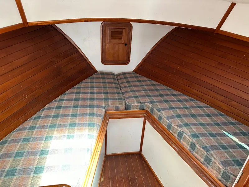 Slide: The Image of Cozy cabin interior of 1988 Black Watch 30 EXPRESS with wooden paneling and plaid bedding. - 5