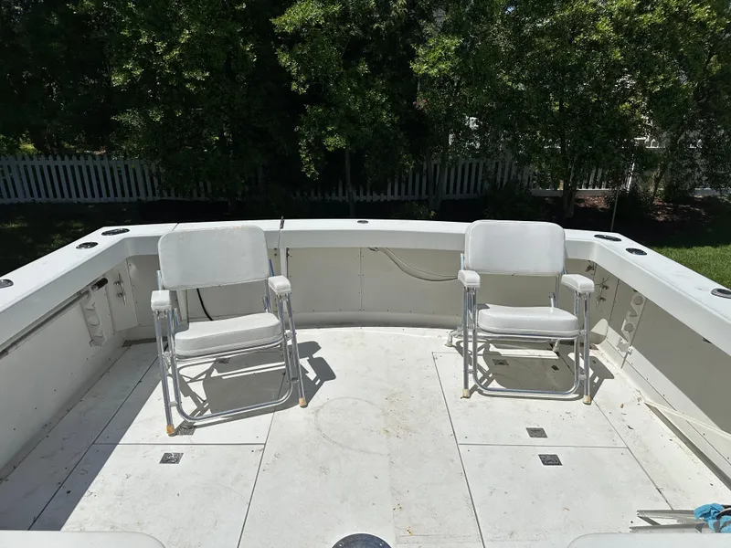 Slide: The Image of Two white chairs on the deck of a 1988 Black Watch 30 EXPRESS boat. - 7