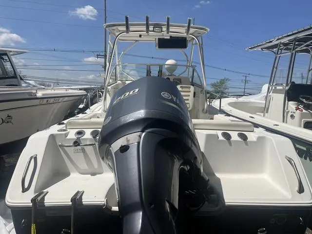 Slide: The Image of 2012 Sea Hunt 225 Victory W/A boat with Yamaha outboard motor, docked under clear blue sky. - 3