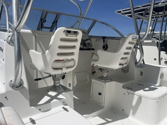 Slide: The Image of 2012 Sea Hunt 225 Victory W/A boat interior with white seating and steering console. - 5