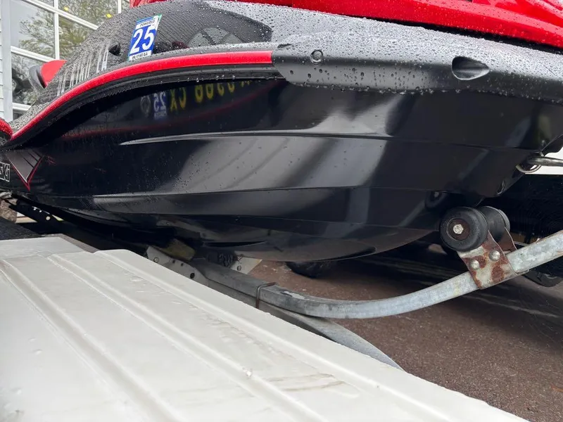 Slide: The Image of 2014 Kawasaki Jet Ski Ultra 310X on trailer, black and red, wet surface. - 10