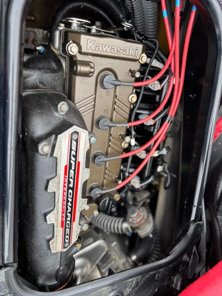 Slide: The Image of 2014 Kawasaki Jet Ski Ultra 310X engine with supercharged components and red ignition wires. - 4