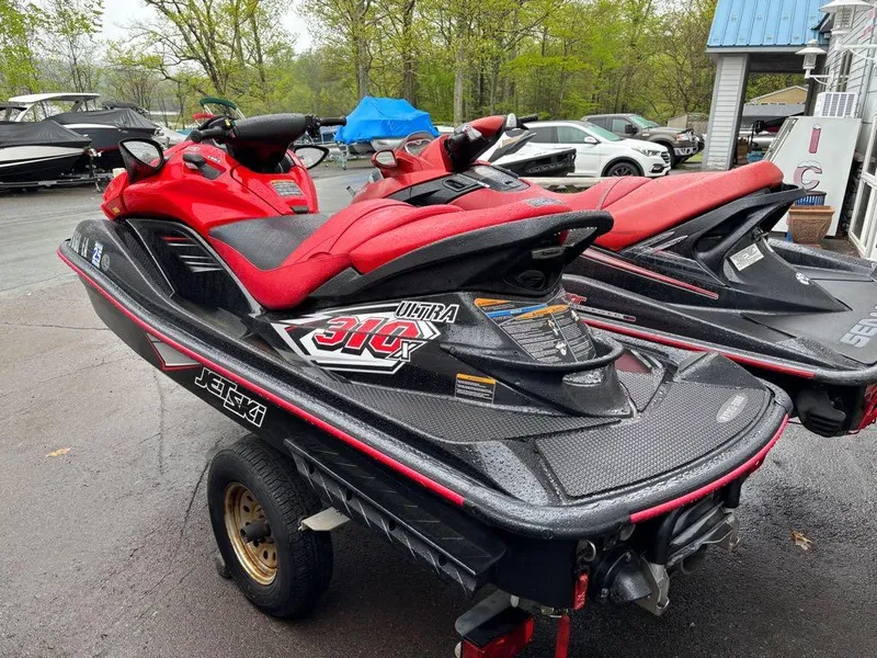Slide: The Image of 2014 Kawasaki Jet Ski Ultra 310X in red, parked on a trailer, ready for adventure. - 5