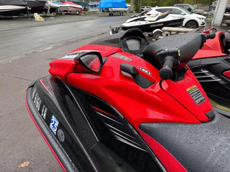 Slide: The Image of Red 2014 Kawasaki Jet Ski Ultra 310X parked on wet pavement. - 8