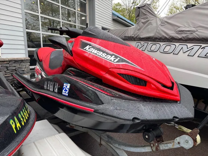 Slide: The Image of 2014 Kawasaki Jet Ski Ultra 310X in vibrant red, parked outdoors. - 9