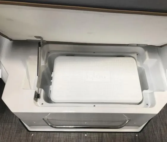 Slide: The Image of 2024 Cobalt R6 Surf boat cooler compartment with open lid. - 13