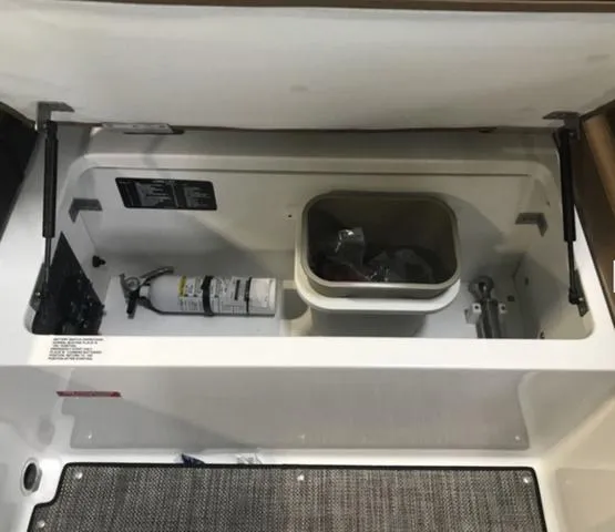 Slide: The Image of 2024 Cobalt R6 Surf storage compartment with fire extinguisher and accessories. - 15