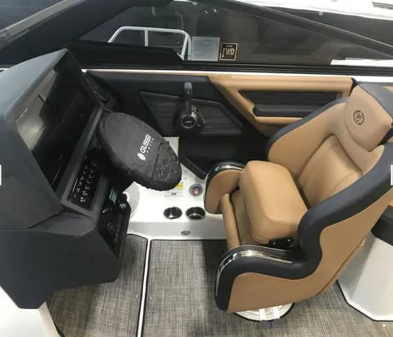 Slide: The Image of 2024 Cobalt R6 Surf boat interior with tan seating and modern dashboard controls. - 8