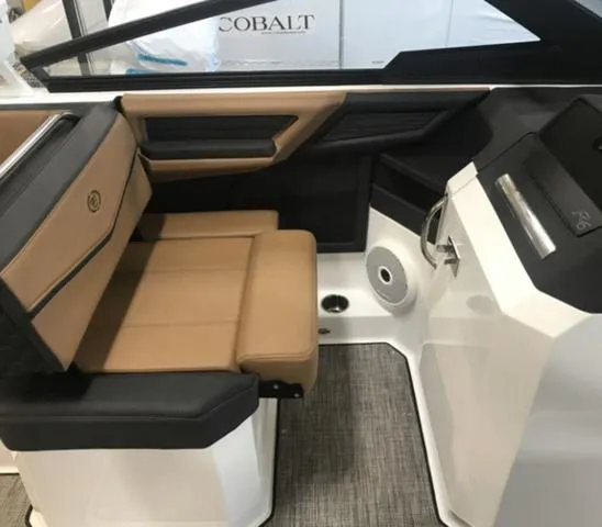Slide: The Image of 2024 Cobalt R6 Surf boat interior with tan and black seating, modern design. - 9