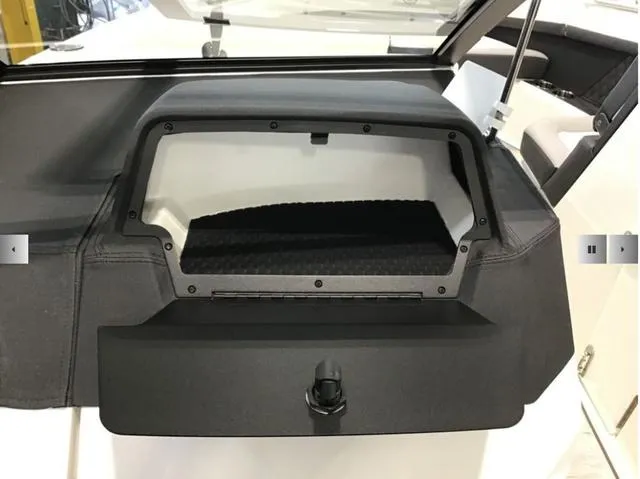 Slide: The Image of 2024 Cobalt R8 boat storage compartment with open lid, showcasing interior space. - 12