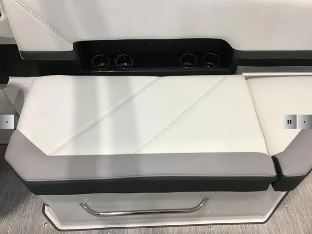 Slide: The Image of 2024 Cobalt R8 boat seat with cup holders, featuring sleek white and gray upholstery. - 15