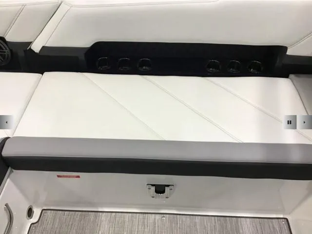 Slide: The Image of 2024 Cobalt R8 boat interior with white cushioned seating and sleek design. - 17