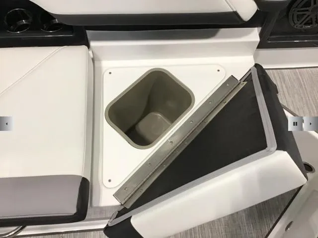 Slide: The Image of 2024 Cobalt R8 boat interior with open storage compartment and cushioned seating. - 19