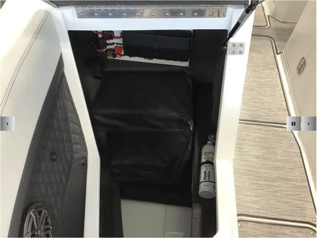 Slide: The Image of 2024 Cobalt R8 boat storage compartment with fire extinguisher and speaker. - 5