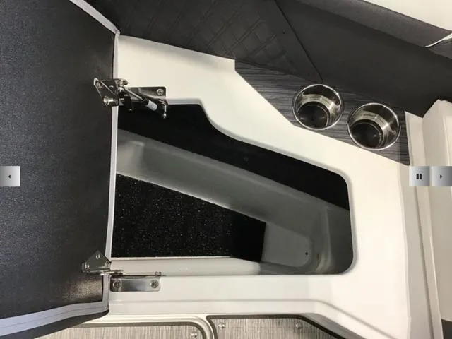 Slide: The Image of 2024 Cobalt R8 boat interior storage compartment with cup holders. - 6